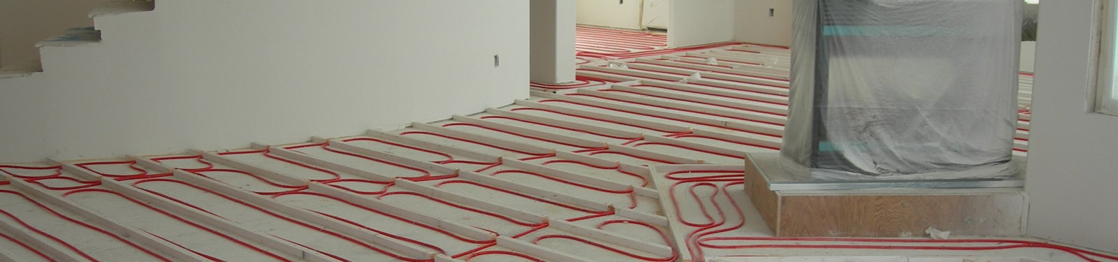 PEX tubing laid between sleeper wood strips prior to a gypsum cement pour