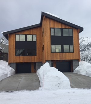 Condos with heaps of snow everywhere except for the completely clear driveways