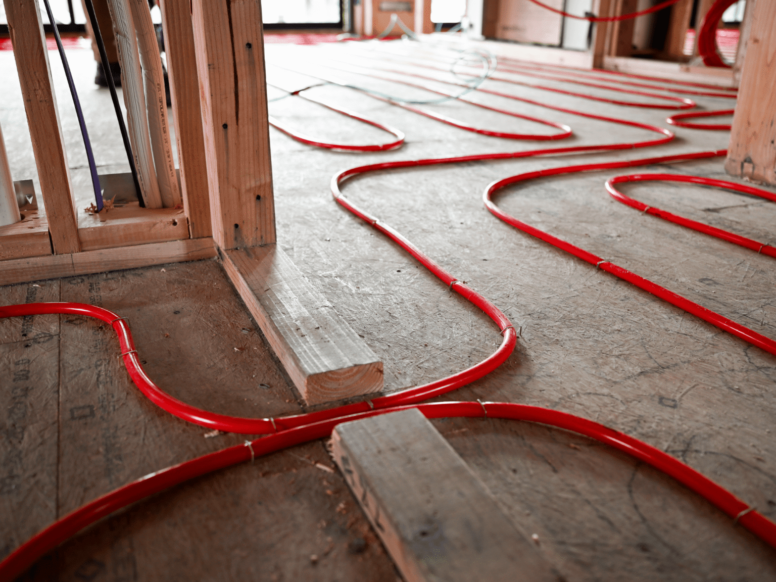 red heating tubes laid out on subfloor