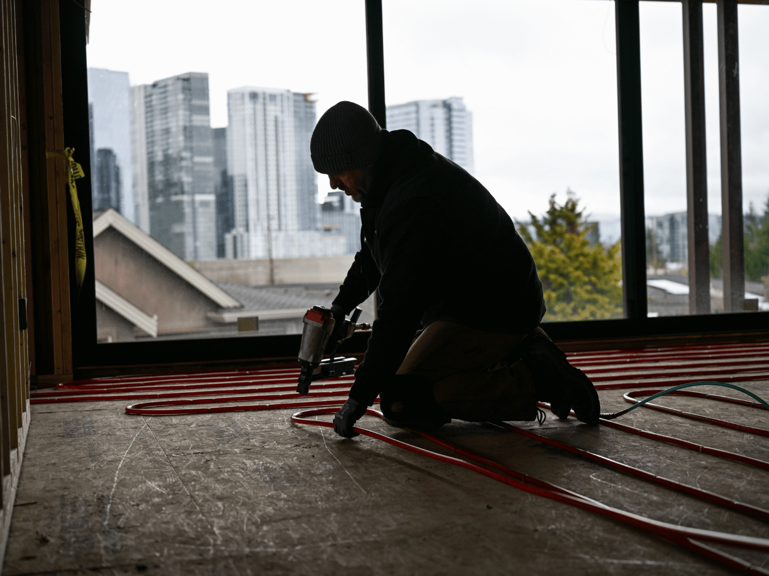 Janes worker kneeling and working on install