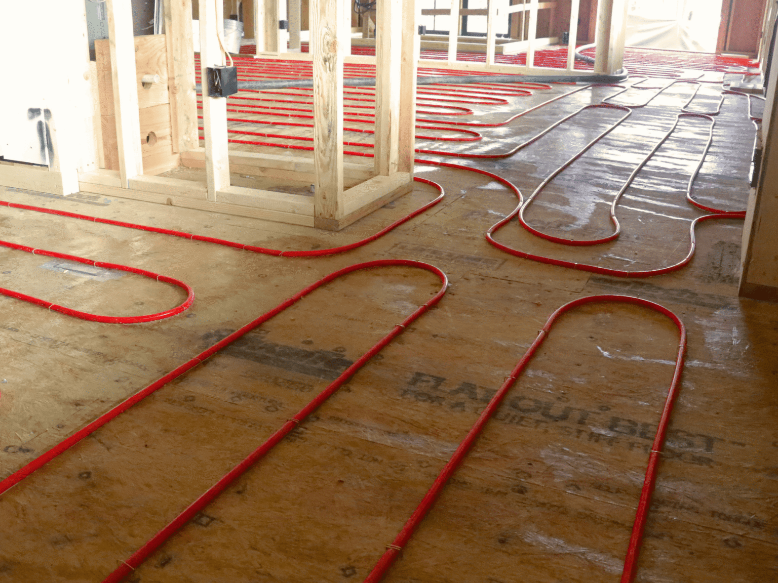 red heating tubes laid out on subfloor