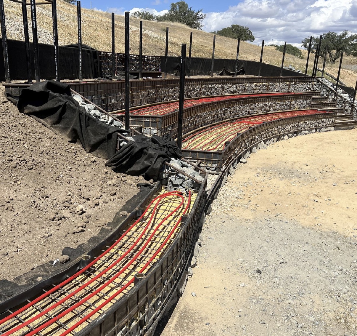 Red pvc laid out on benches of outdoor amphitheater