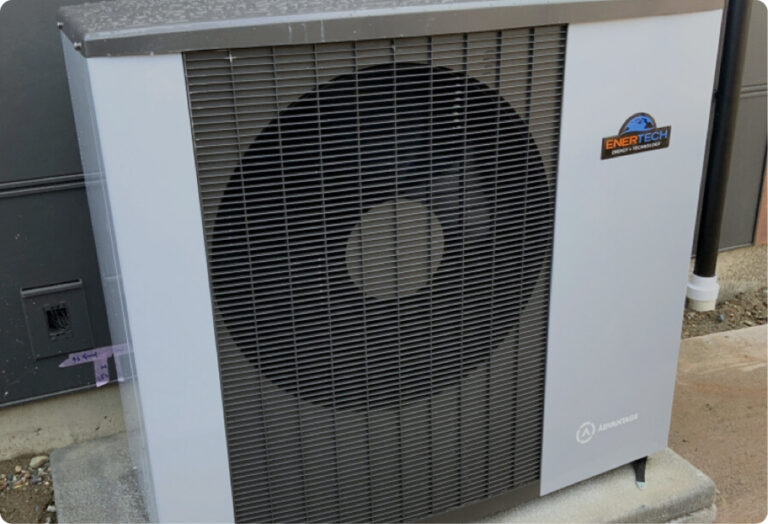 Modern, light grey outdoor Air-to-water heat pump unit featuring a prominent circular black fan grill, a colorful brand logo, and compact design.