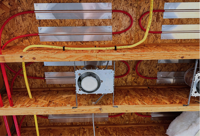 Heating system stapled to bottom of flooring