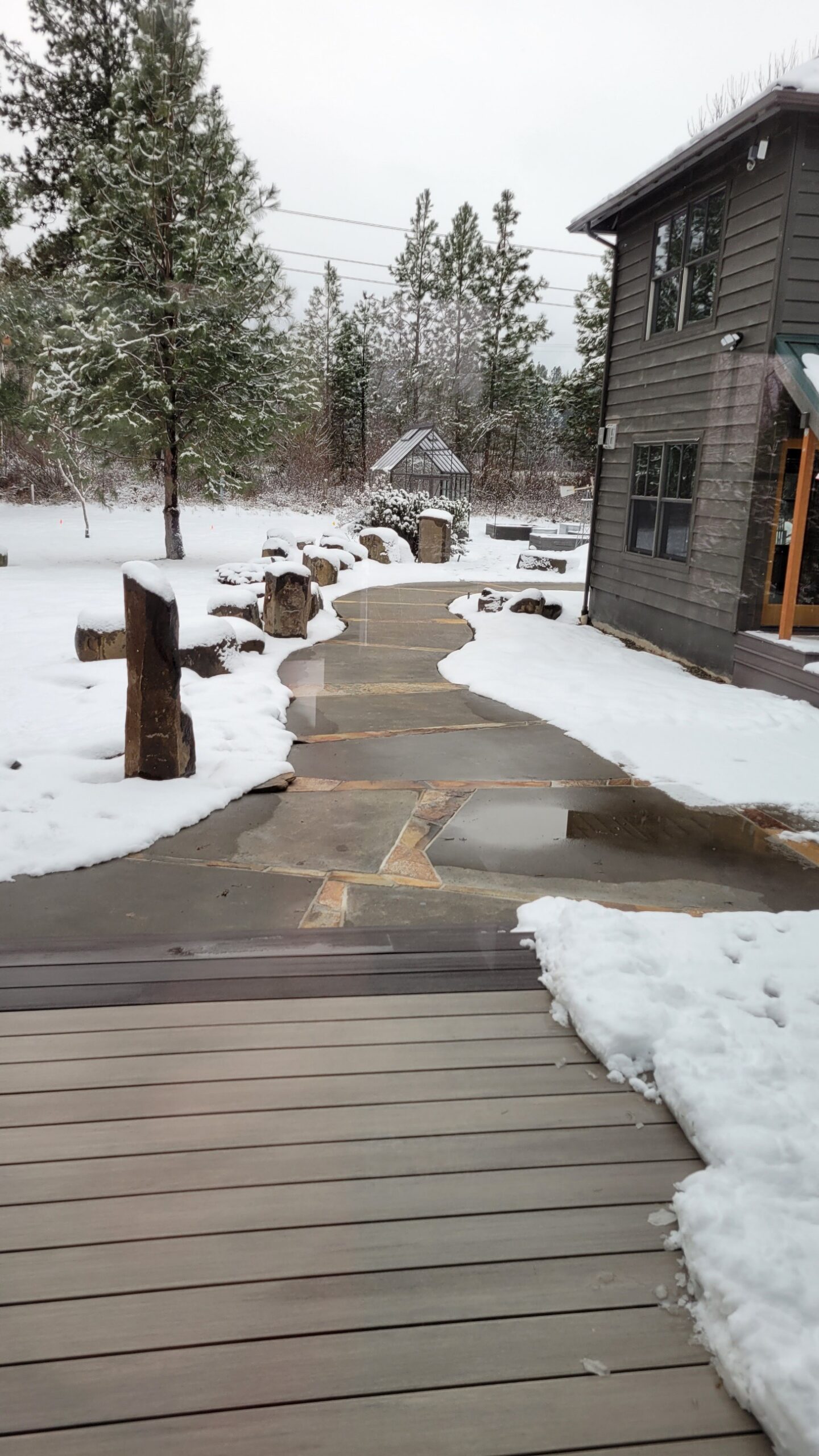 Snow melted from sidewalk with snow on either side