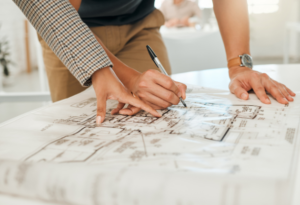CLose up on contractor and architect looking over home plans