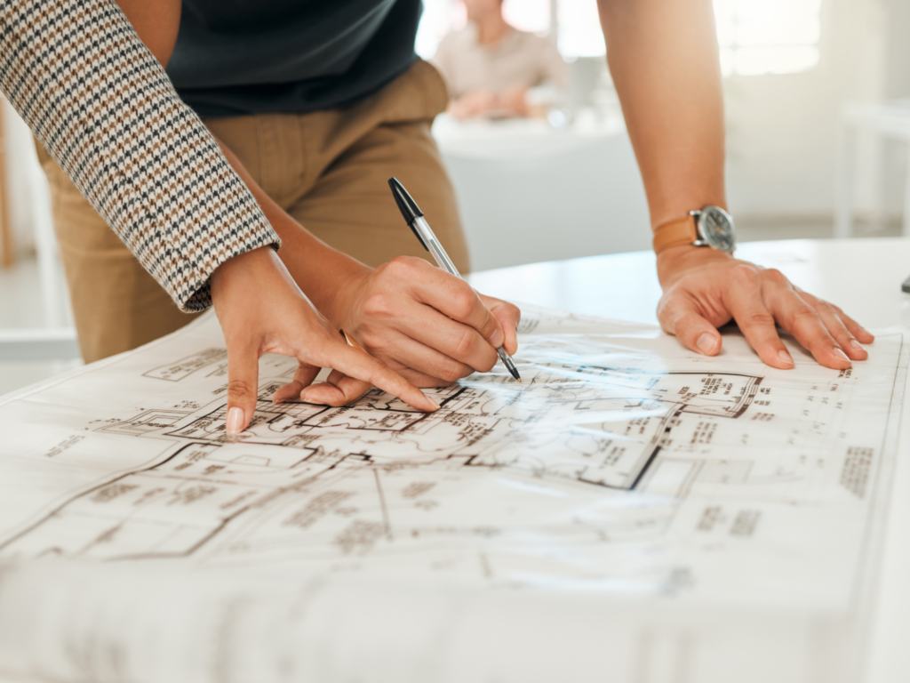 two people scanning home plans