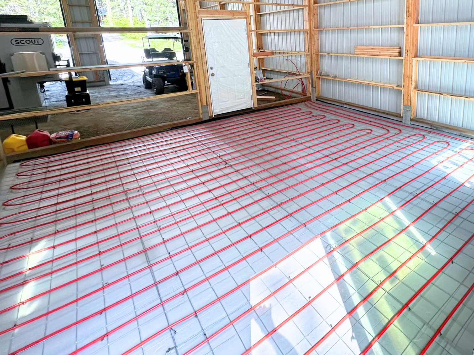 Radiant heating red pexa tubes covoring floor of shop