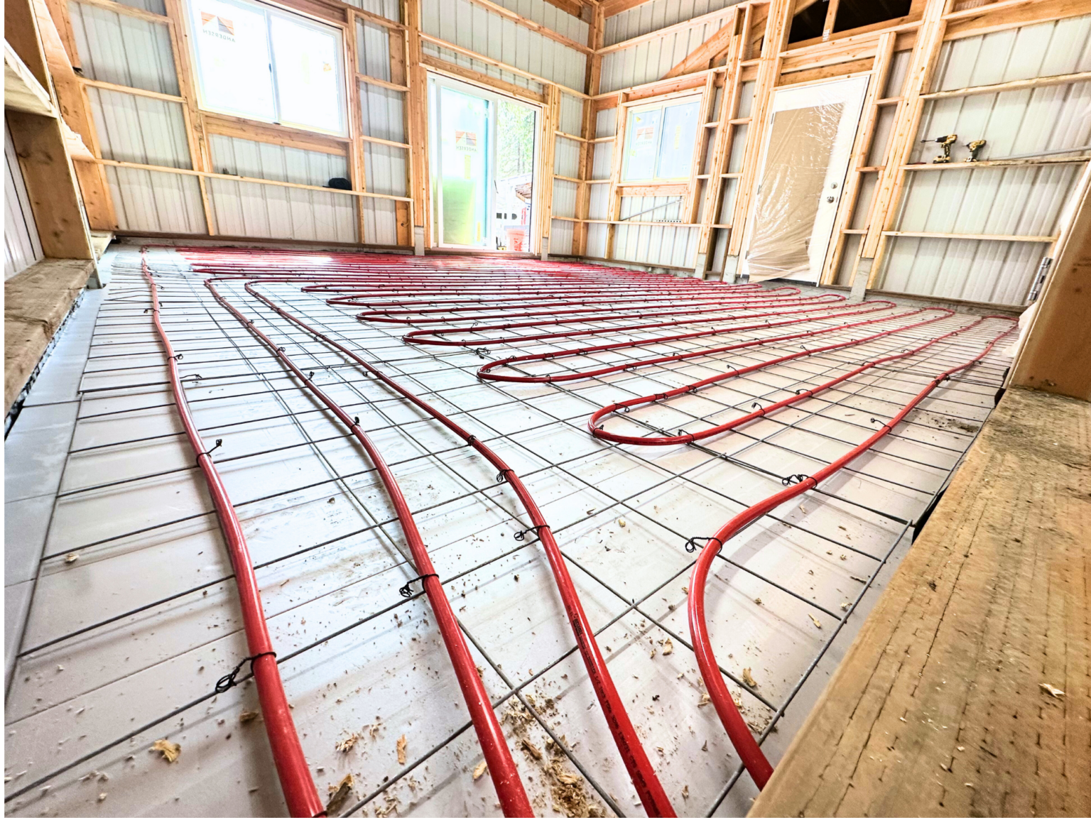 Radiant heating red pexa tubes covoring floor of shop