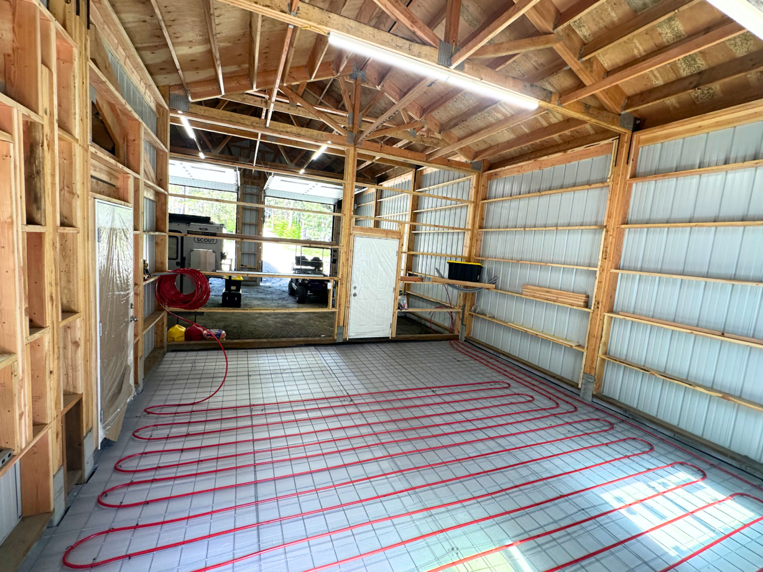 Radiant heating red pexa tubes covoring floor of shop