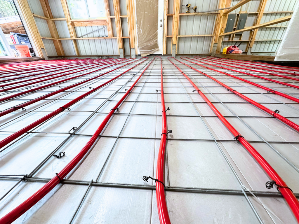 Radiant heating red pexa tubes covoring floor of shop