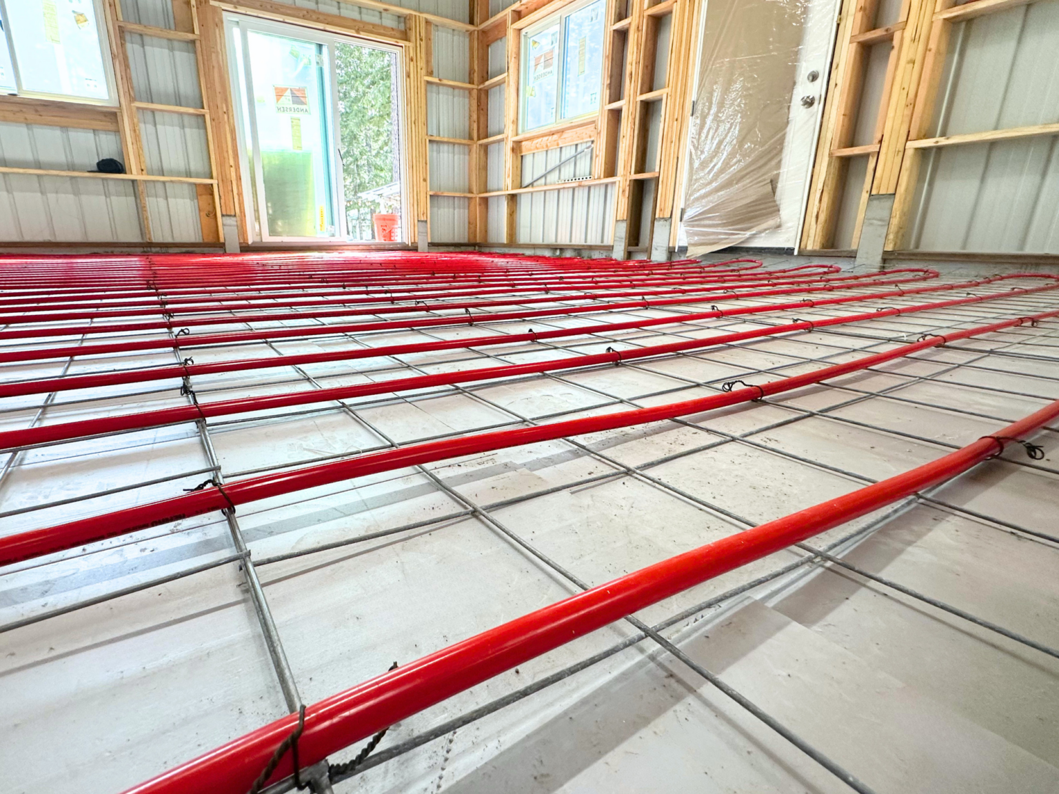 Radiant heating red pexa tubes covoring floor of shop