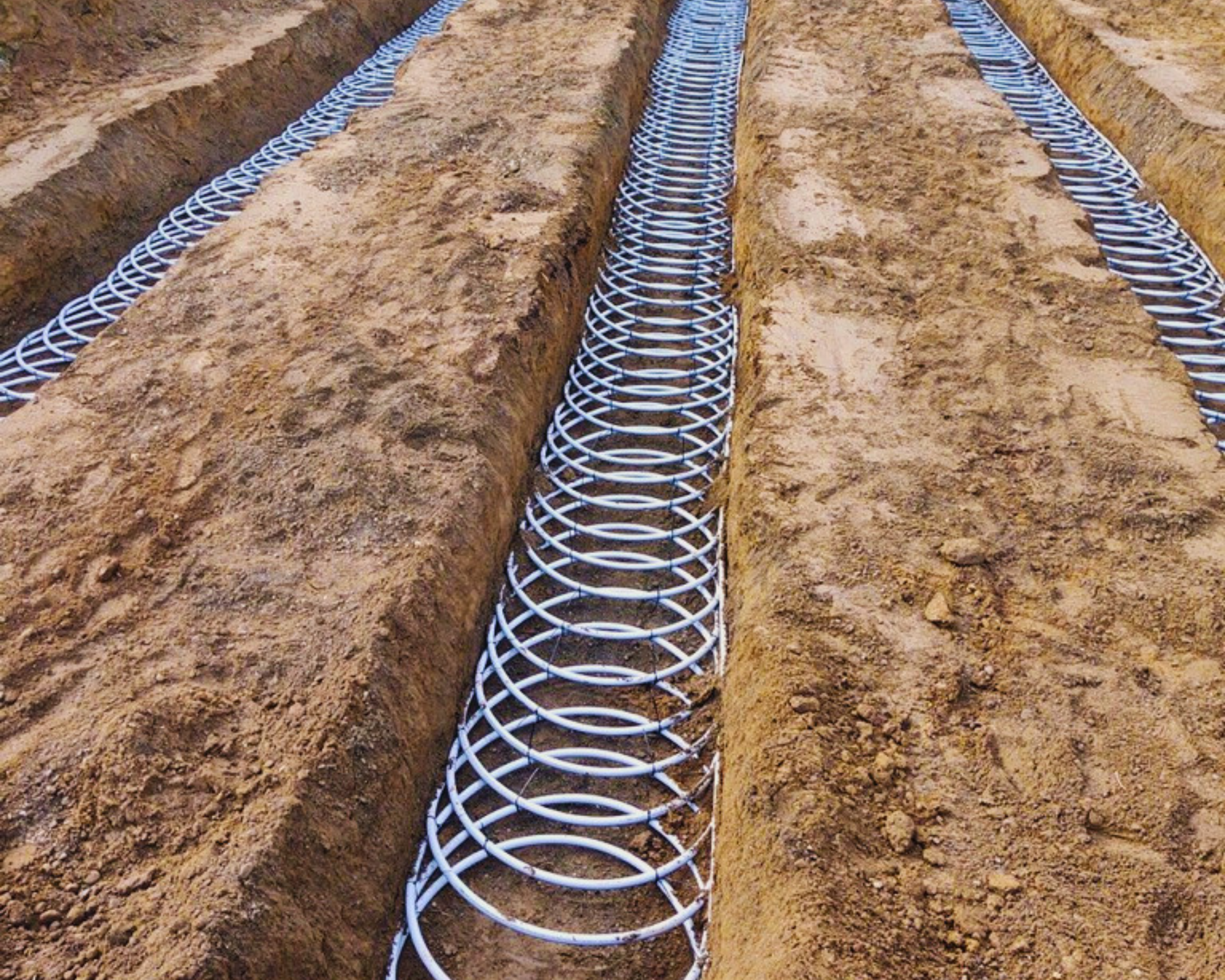 Geo loops being added in ground for geothermal heating install