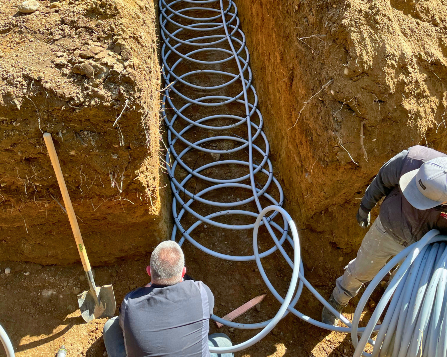 Geo loops being added in ground for geothermal heating installation