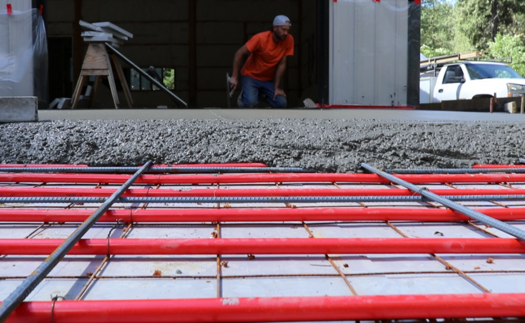 Concrete being poured over hydronic tubing for a snowmelt driveway