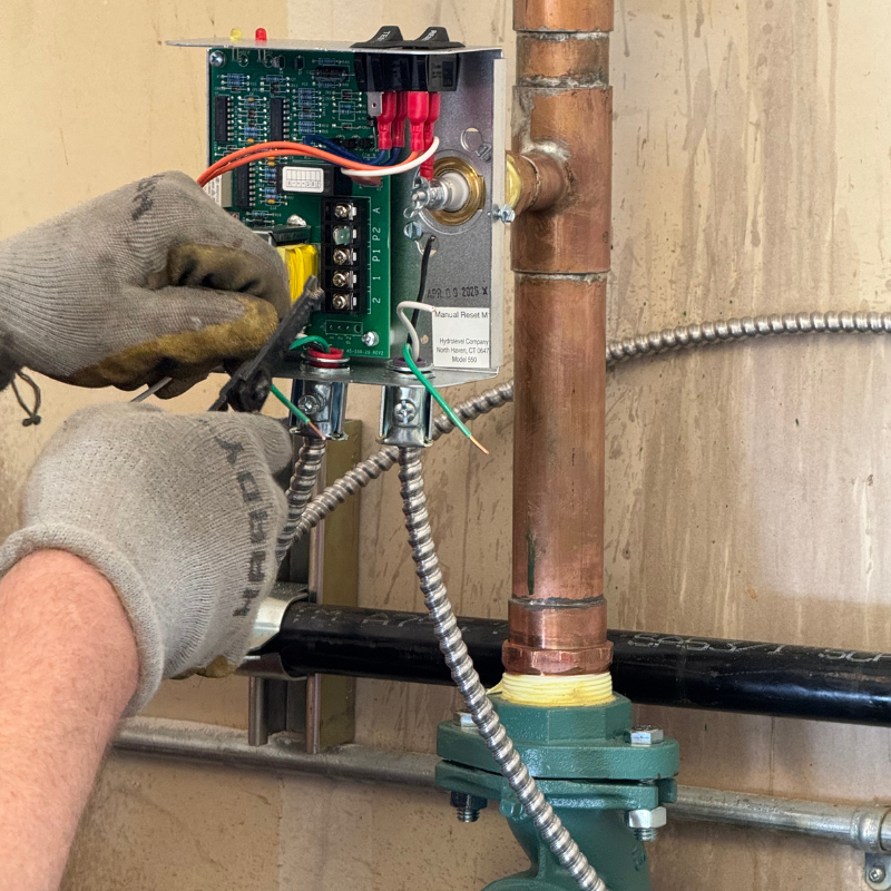 technician wiring new boilers for a commercial building