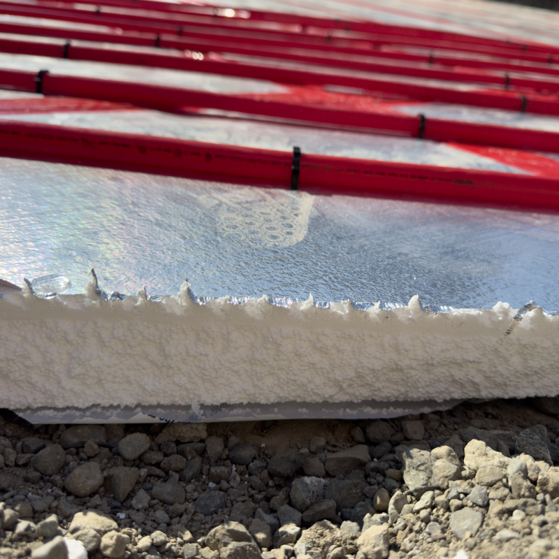 foil-faced foam layers shown with pex tubing stapled down for heated driveway install