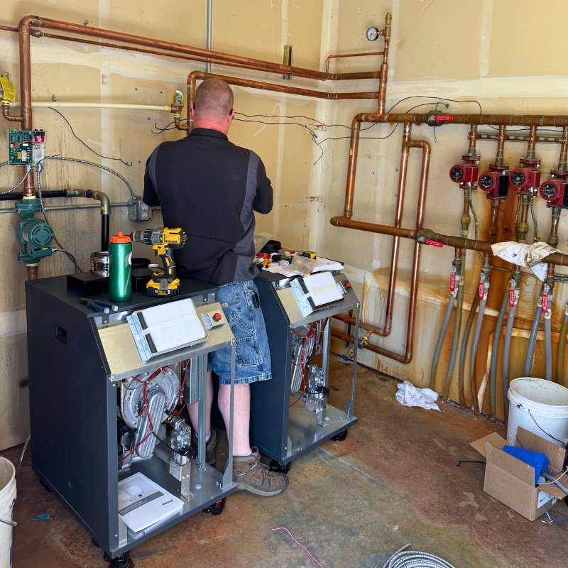 Technician installing new dual-boiler system for commercial use