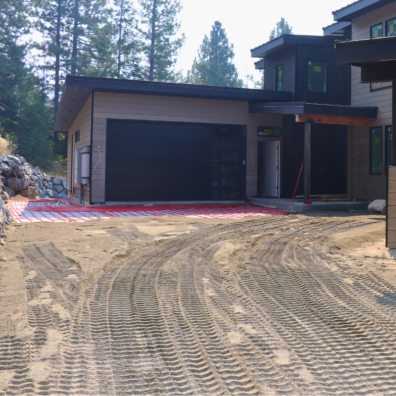 Sand layer being added for a snowmelt driveway