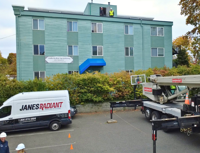 Staging area for new boiler and hot water tank installation on rooftop